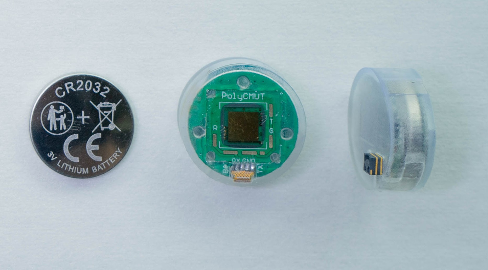 EchoButton ultrasound sensor in front and side views, next to a CR2032 coin cell for scale.